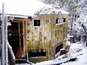 house clad in used tomato can tiles in Patagonia’s dense wilderness.